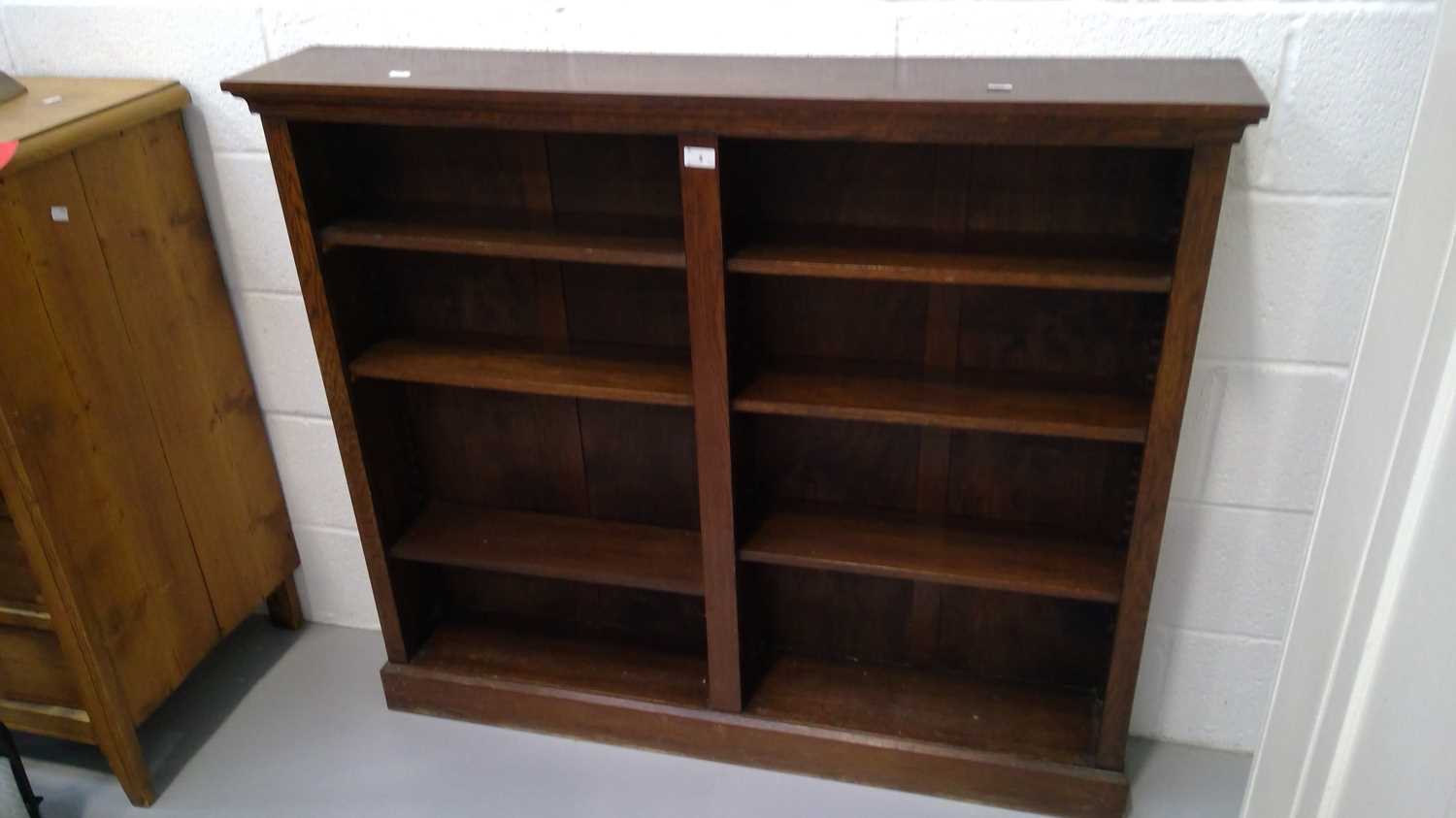 Lot 5 - A twin bay open oak bookcase height 107cm...