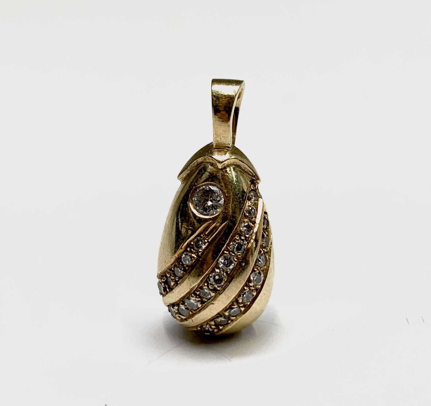 Lot 174 - A pretty diamond set gold drop shaped pendant,...