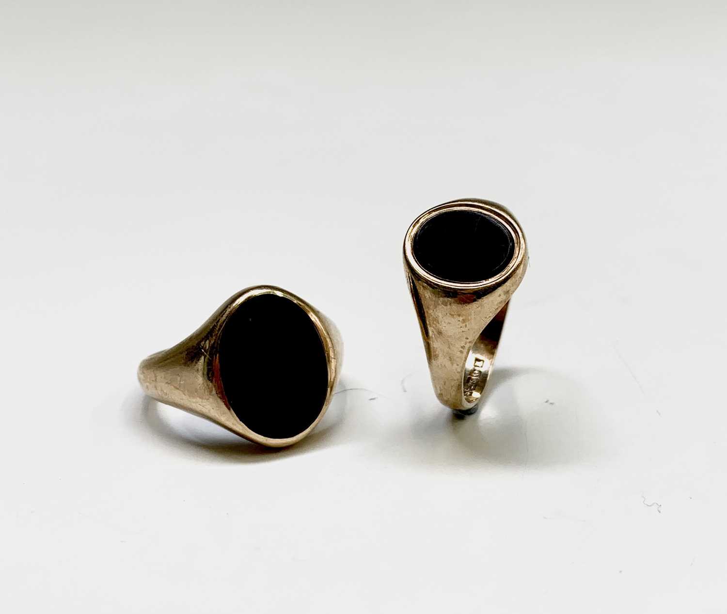 Lot 159 - Two 9ct gold signet rings each set with black...