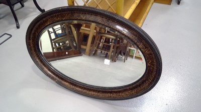 Lot 69 - Oval framed wall hanging mirror with a beveled...
