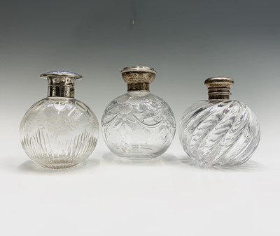 Lot 1049 - Three spherical glass toilet bottles each with...