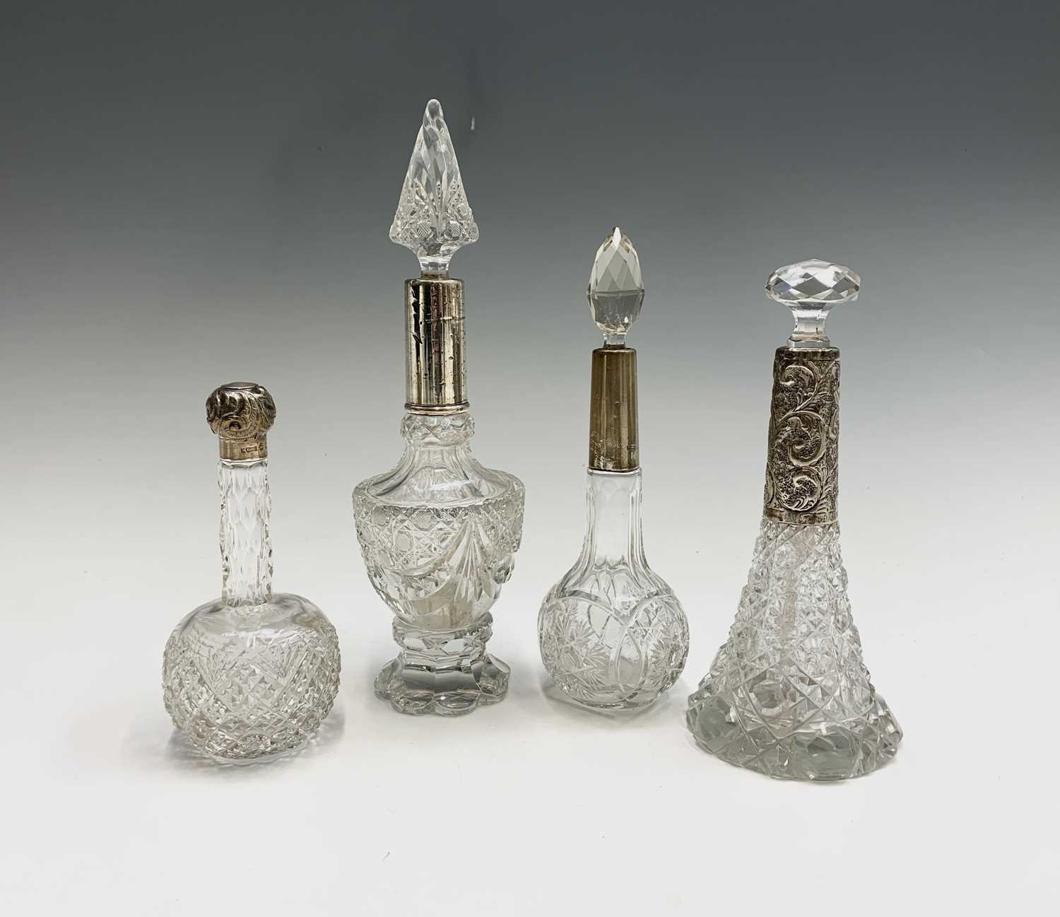 Lot 1007 - Four cut glass tall toilet bottles each with...