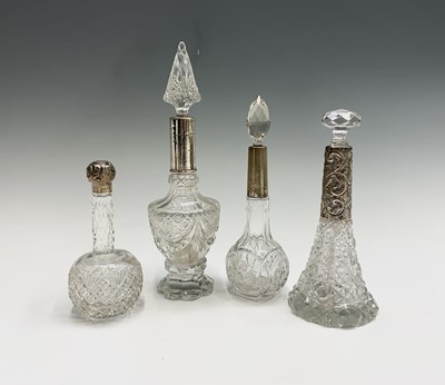 Lot 1007 - Four cut glass tall toilet bottles each with...