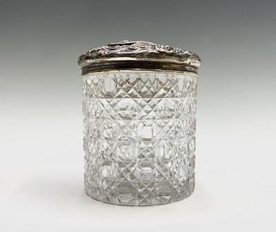 Lot 1051 - Four cut glass toilet jars each with silver...