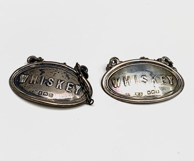 Lot 1005 - A pair of silver Whiskey noggin labels...