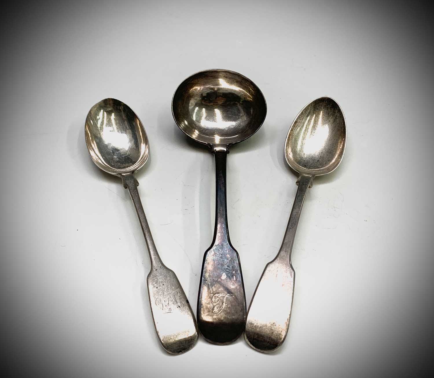 Lot 1076 - A silver fiddle pattern sauce ladle and two...