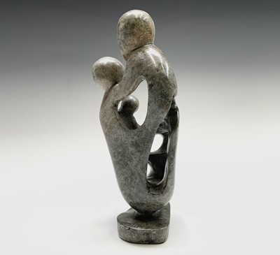 Lot 66 - A carved stone figure of a stylised family...