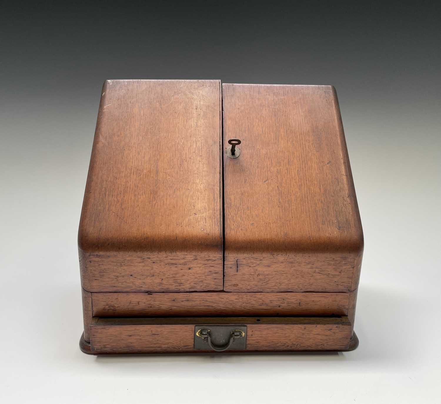 Lot 22 - An oak stationery cabinet, 1920s, with two...