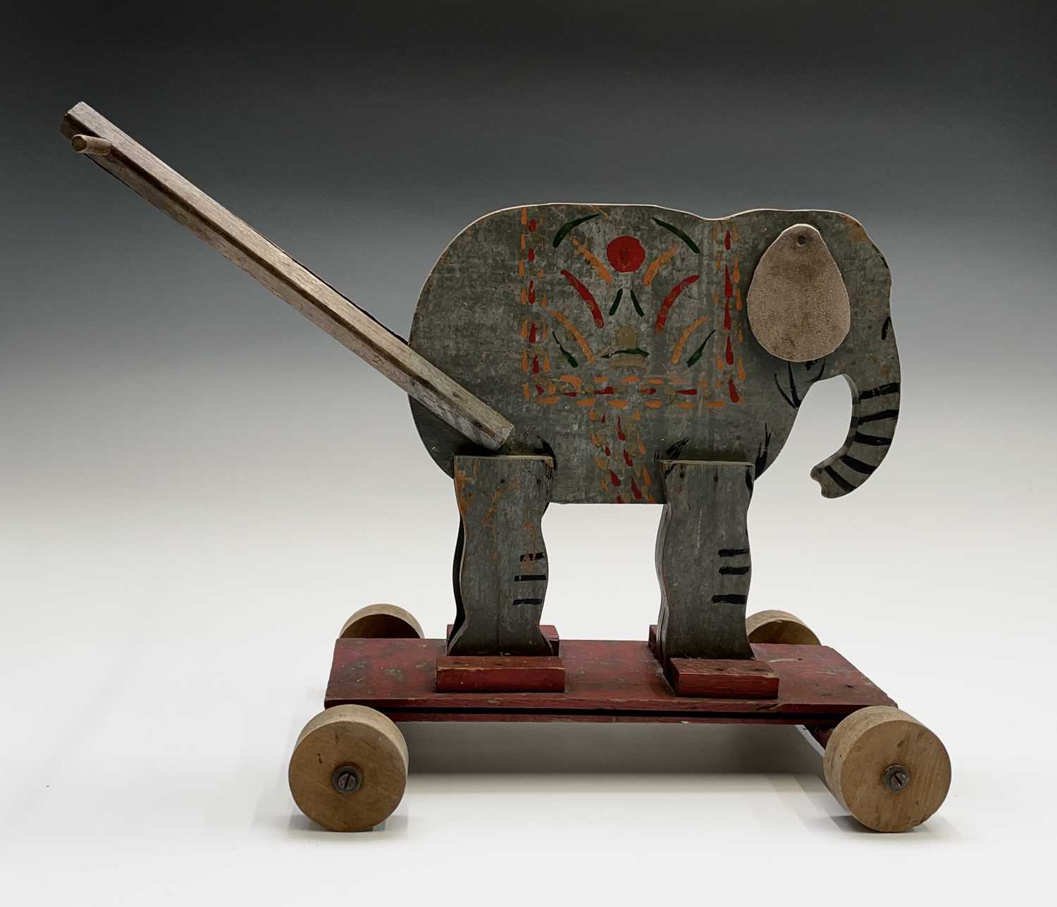 Lot 85 - A 20th century wooden elephant push-along toy,...