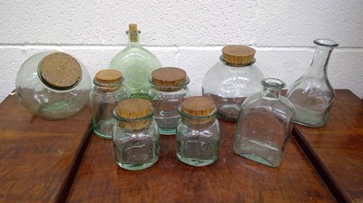 Lot 215 - Glass storage jars most with cork stoppers.