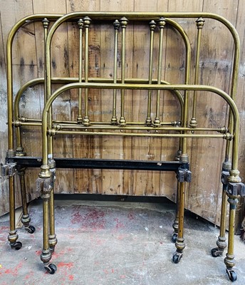 Lot 3199 - Two Victorian brass single beds, with railed...