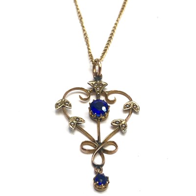 Lot 2629 - An Art Nouveau gold pendant set blue stones...