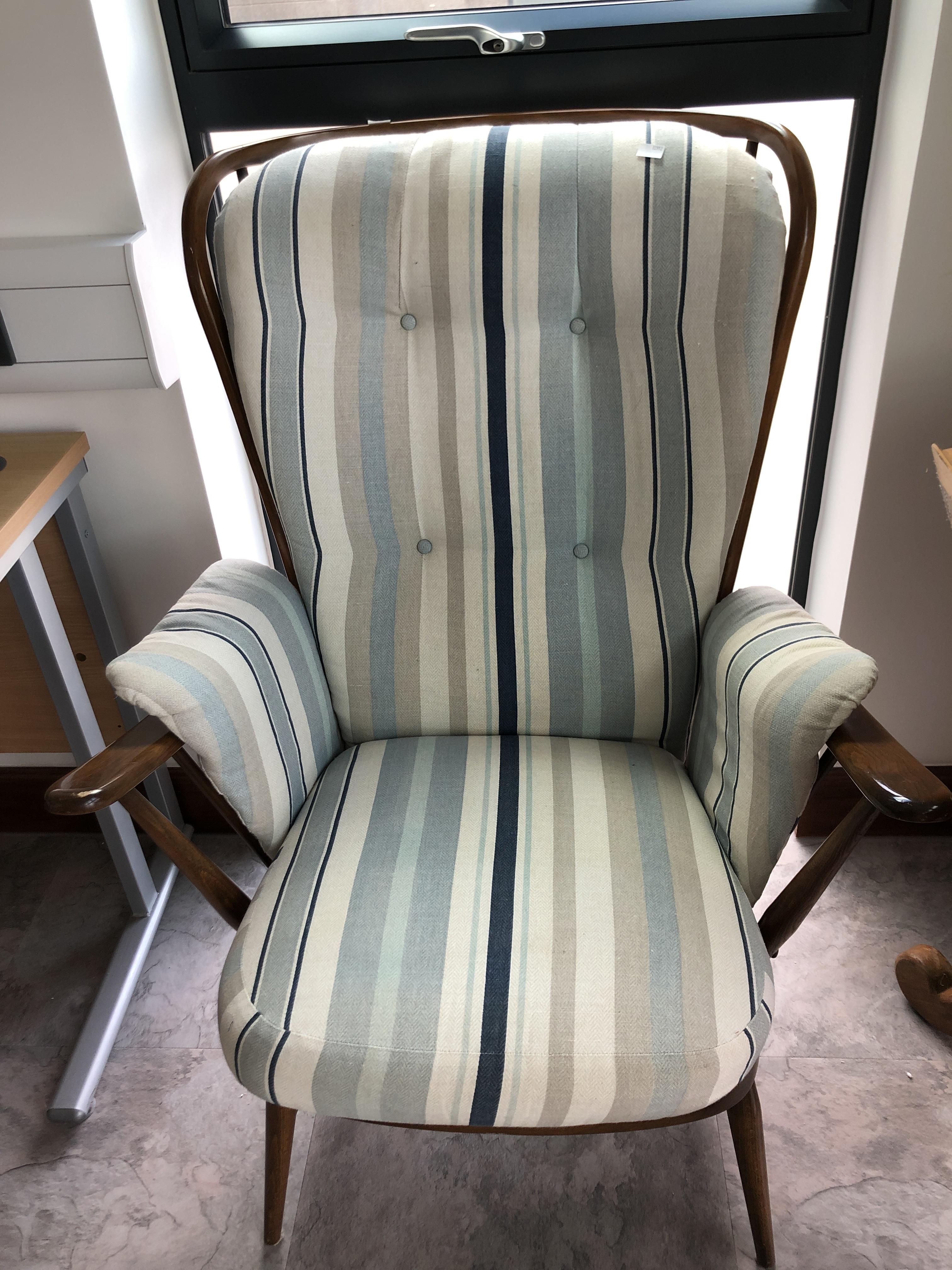 Lot 293 Ercol armchair, with makers badge.