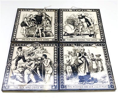 Lot 947 - Four black and white tiles depicting scenes...