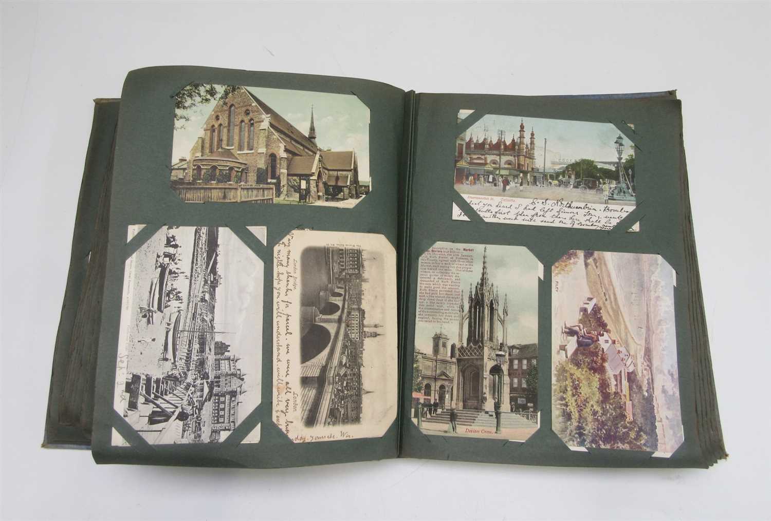 Lot 59 - An early 20th century postcard album and...