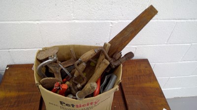 Lot 273 - A box of tools that includes saws, hand-crank...