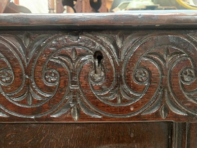 Lot 24 - A carved oak coffer, 17th century, with scroll...