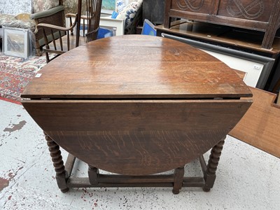 Lot 92 - An oak gateleg dining table, the oval top on...