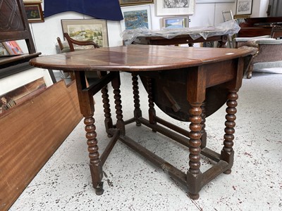 Lot 92 - An oak gateleg dining table, the oval top on...