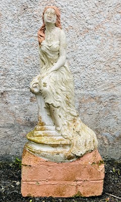 Lot 611 - A garden sculpture of a woman seated on a...