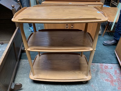 Lot 3062 - An Ercol light elm three tier trolley, with...