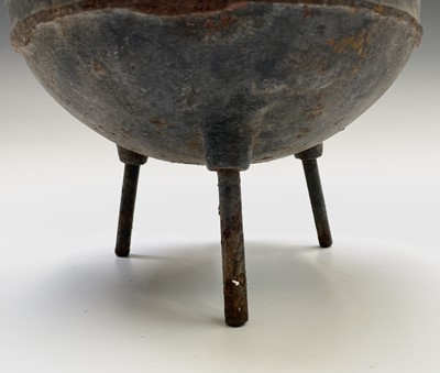 Lot 310 - A cast iron cauldron with handle, raised on...