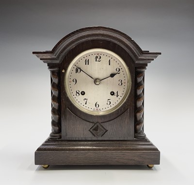 Lot 2905 - An oak cased mantel clock, with twist side...