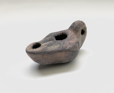 Lot 134 - A Roman terracotta oil lamp, with moulded...