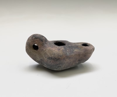 Lot 134 - A Roman terracotta oil lamp, with moulded...