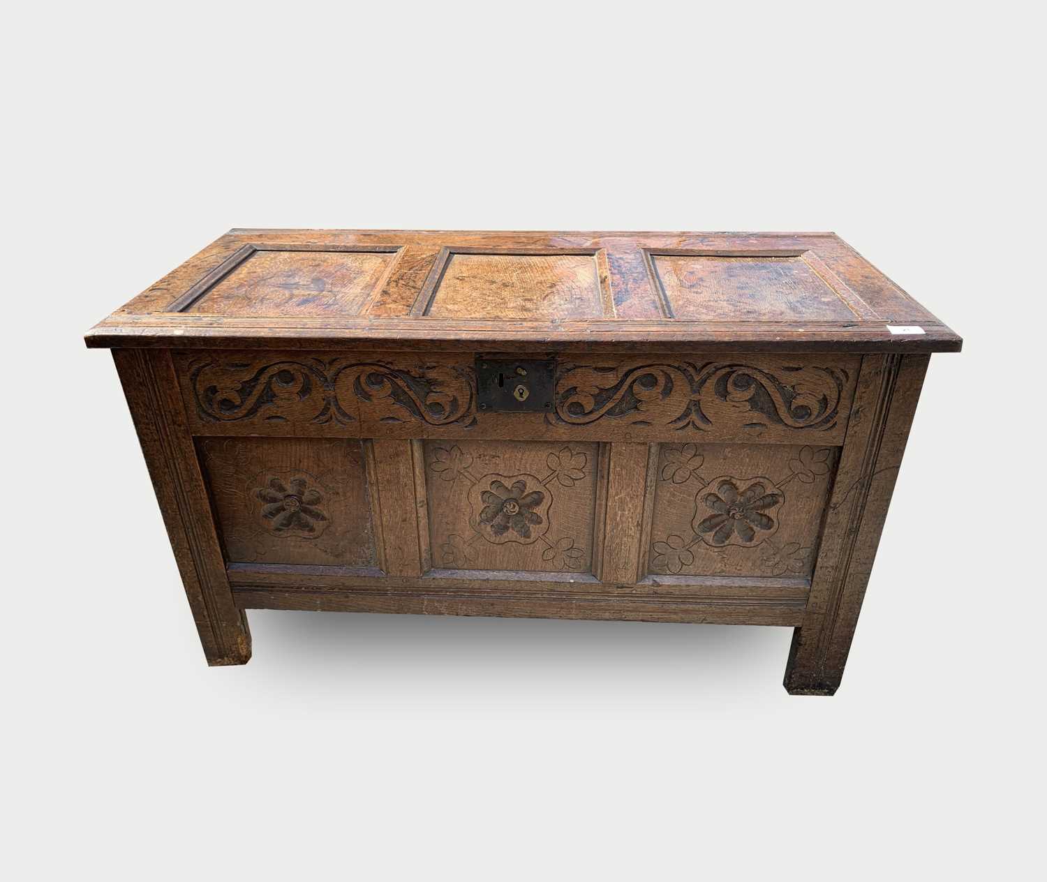 Lot 21 - A carved oak coffer, 17th century, with a...