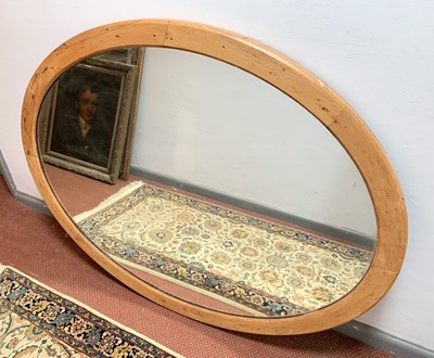 Lot 221 - A Victorian oval pine wall mirror, 121 x 94cm.