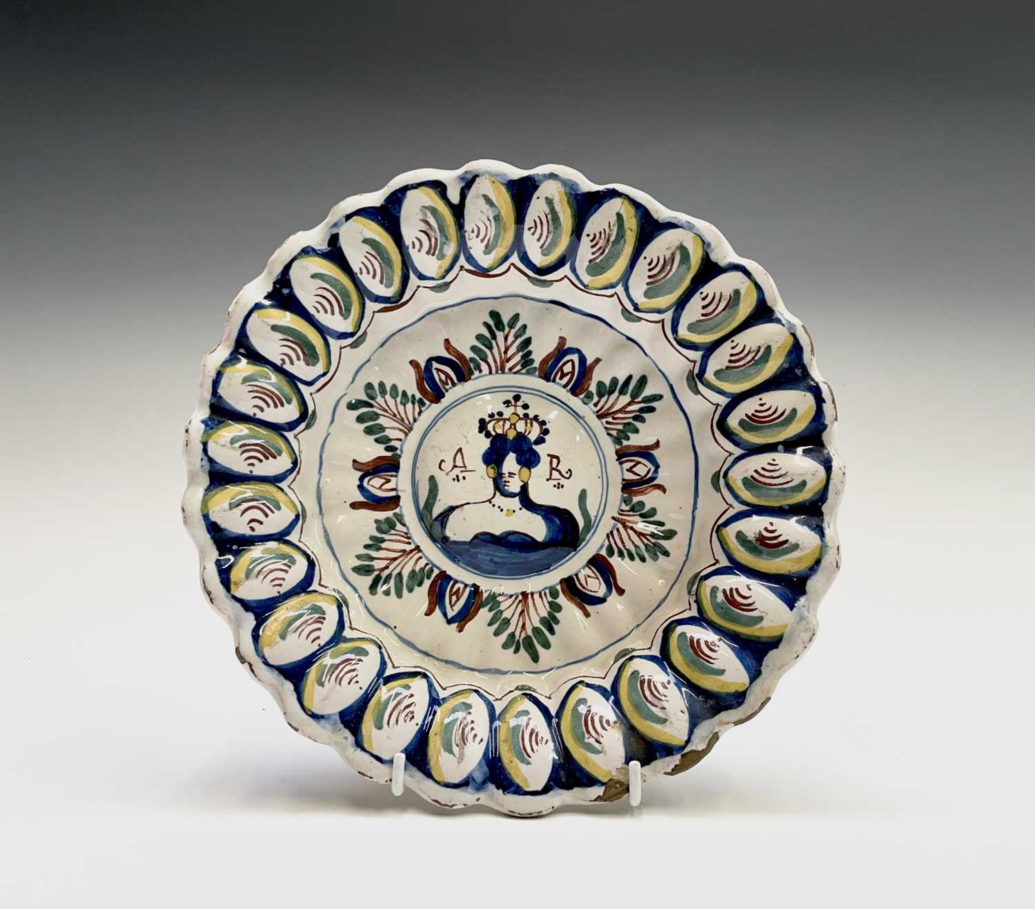 Lot 29 - An English delft polychrome decorated lobed...