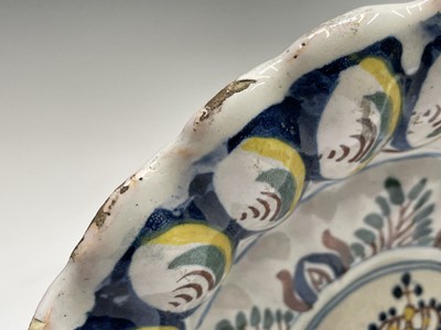 Lot 29 - An English delft polychrome decorated lobed...