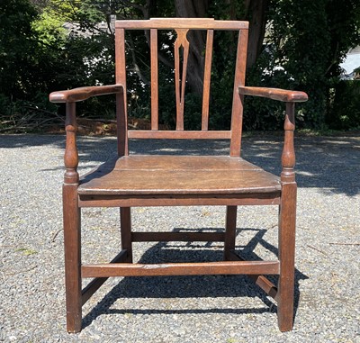 Lot 573 - A George III oak open armchair.