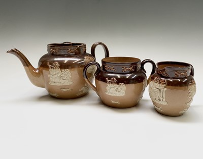 Lot 908 - A Royal Doulton three piece stoneware tea...