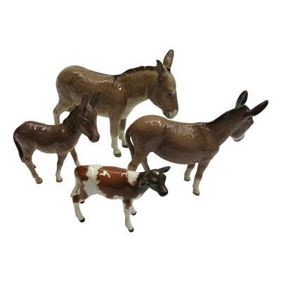 Lot 904 - A Beswick donkey, jenny and foal together with...