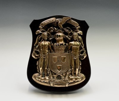 Lot 188 - A cast brass armorial plaque depicting the...