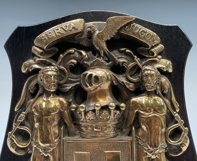 Lot 188 - A cast brass armorial plaque depicting the...