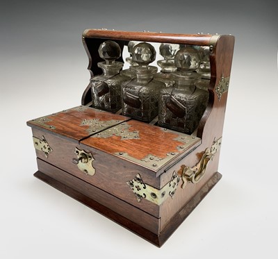 Lot 112 - An Edwardian tantalus, fitted with three...
