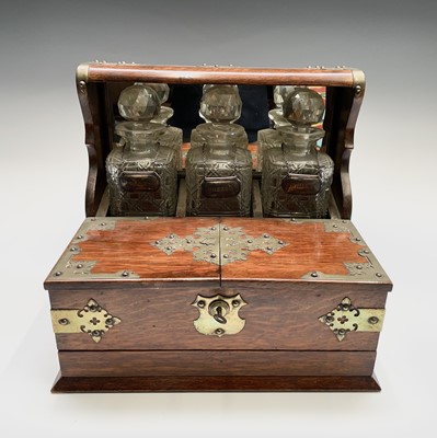 Lot 112 - An Edwardian tantalus, fitted with three...