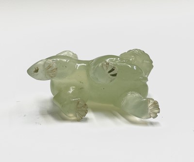 Lot 358 - A Chinese jade dog of fo, on a wooden stand,...