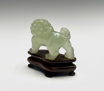Lot 358 - A Chinese jade dog of fo, on a wooden stand,...