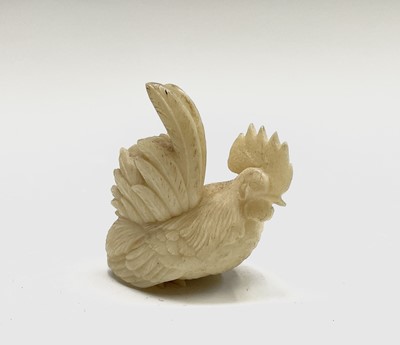 Lot 181 - A carved ivory rooster 40mm high and two horn...