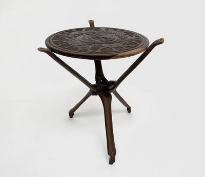 Lot 209 - An African carved hardwood table, raised on a...