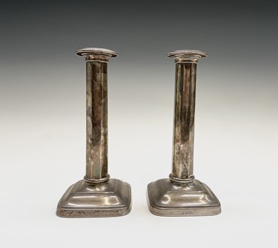 Lot 403 - A pair of Edwardian silver candlesticks...