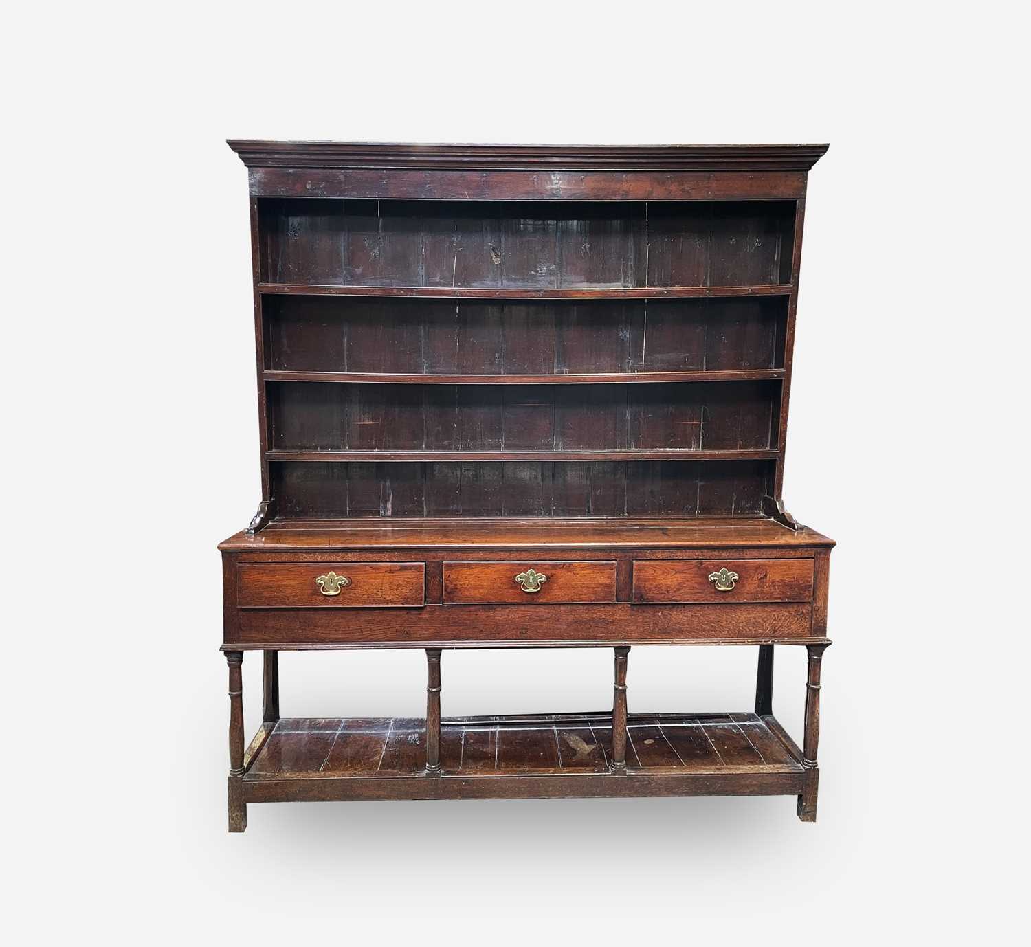 Lot 25 - A George III oak dresser, the rack with three...