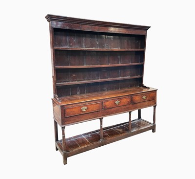 Lot 25 - A George III oak dresser, the rack with three...