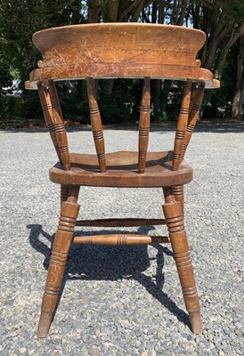 Lot 147 - An elm and beech smokers bow armchair, early...