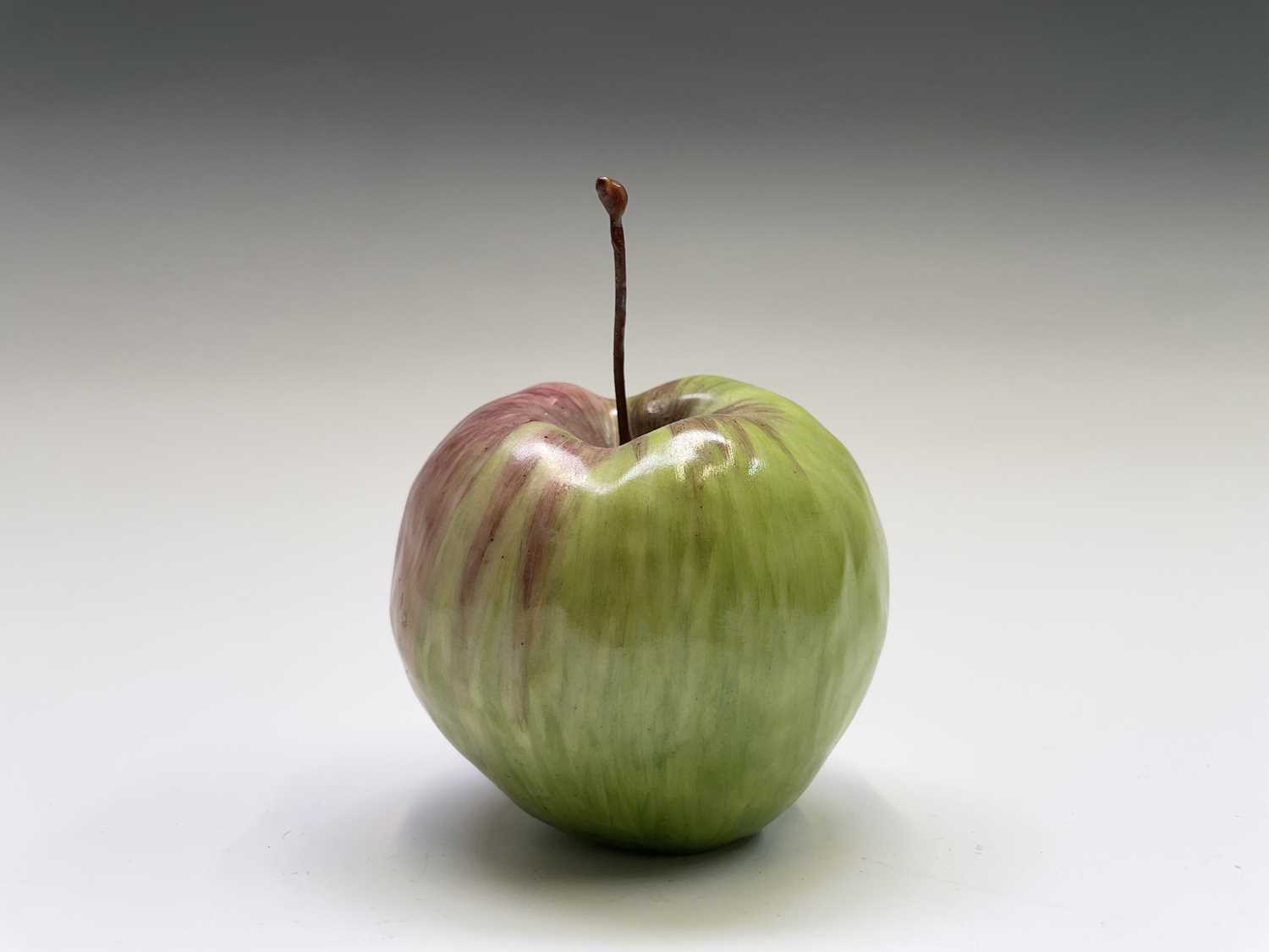Lot 956 - A porcelain sculpture of an apple modelled by...