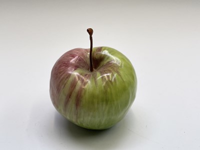Lot 956 - A porcelain sculpture of an apple modelled by...